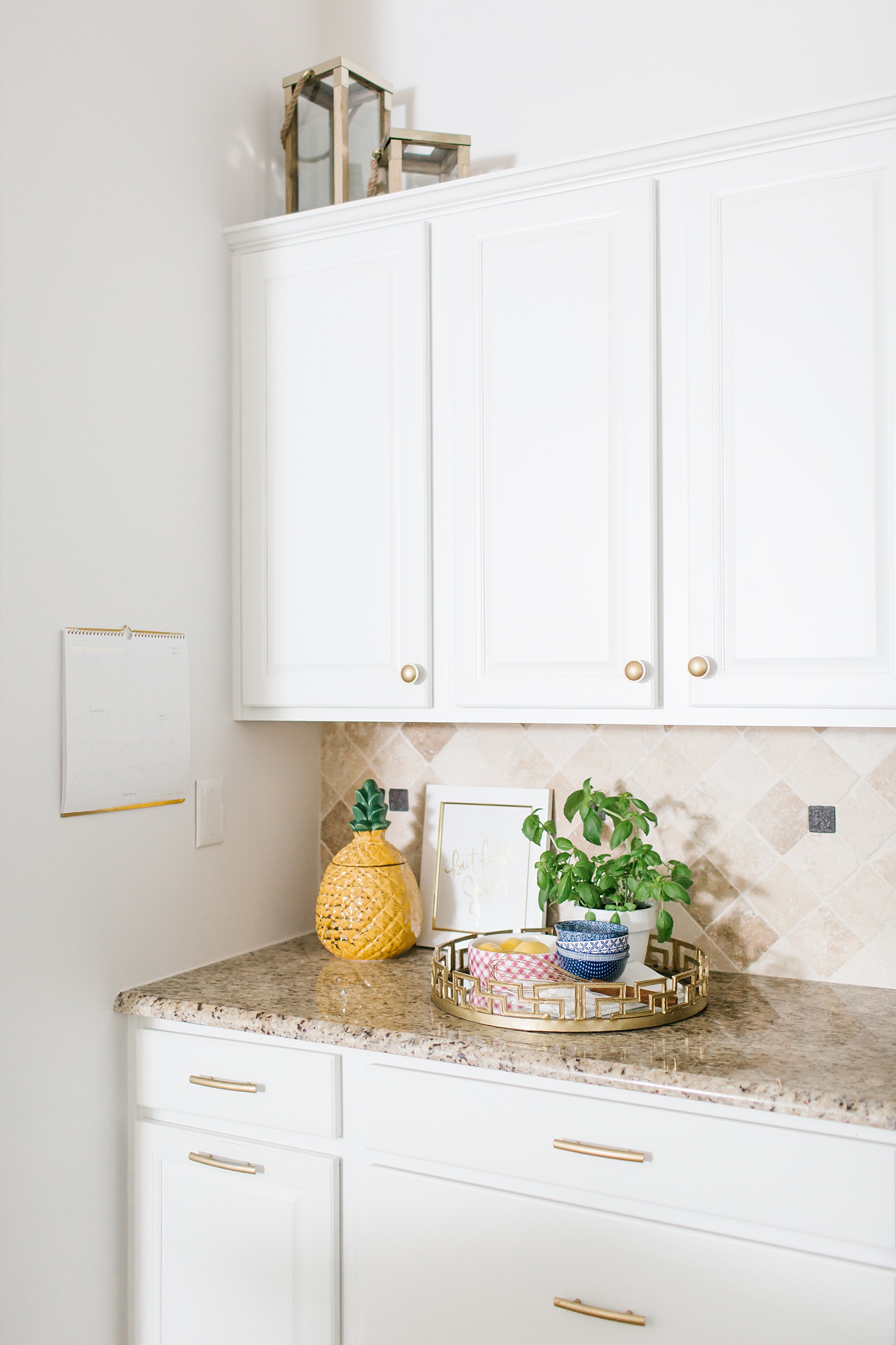 bright white kitchen cabinets with DIY spray painted gold cabinet hardware
