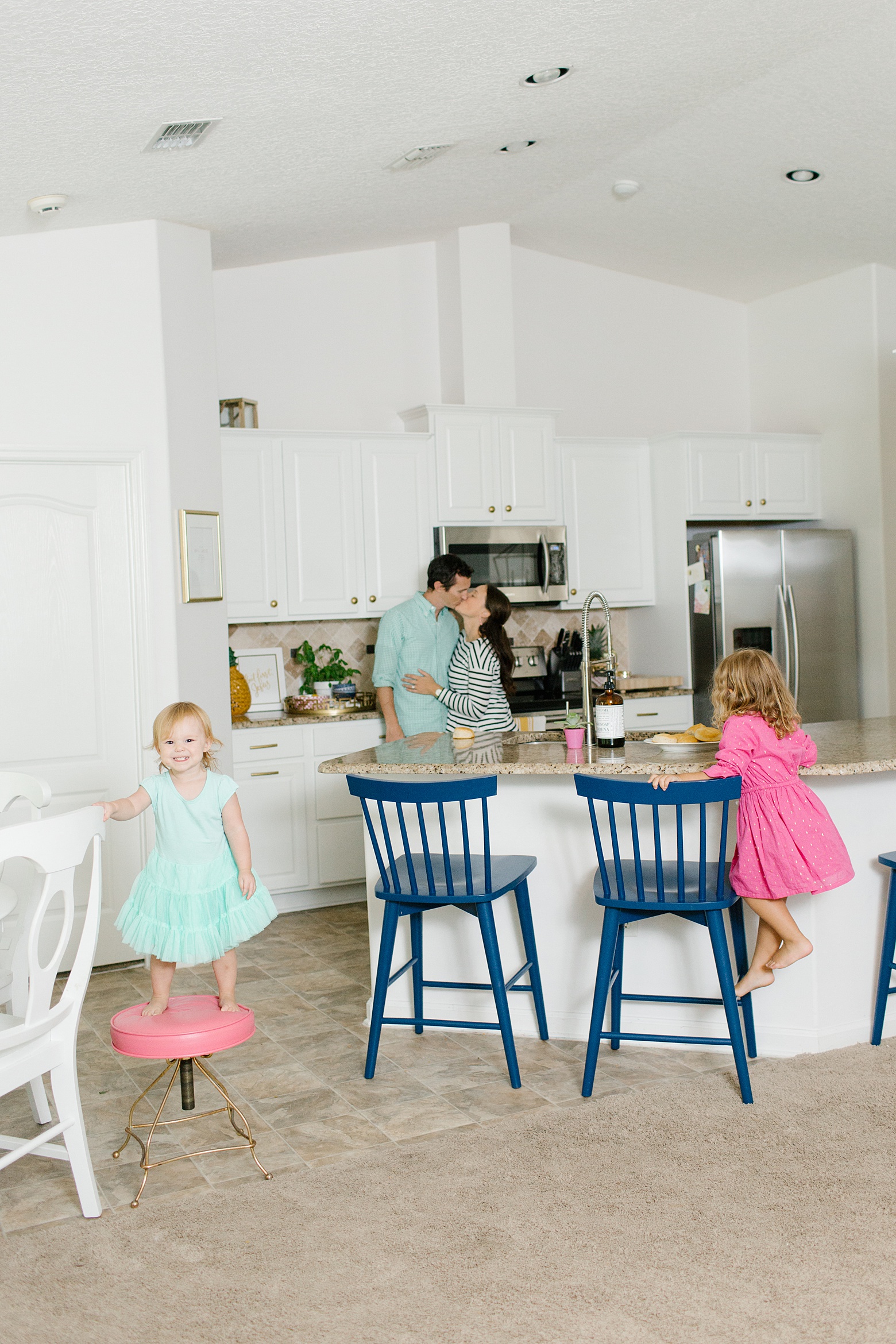 The Martin Family Bright White Kitchen, Navy Bar Stools, white kitchen cabinets, lifestyle family photography